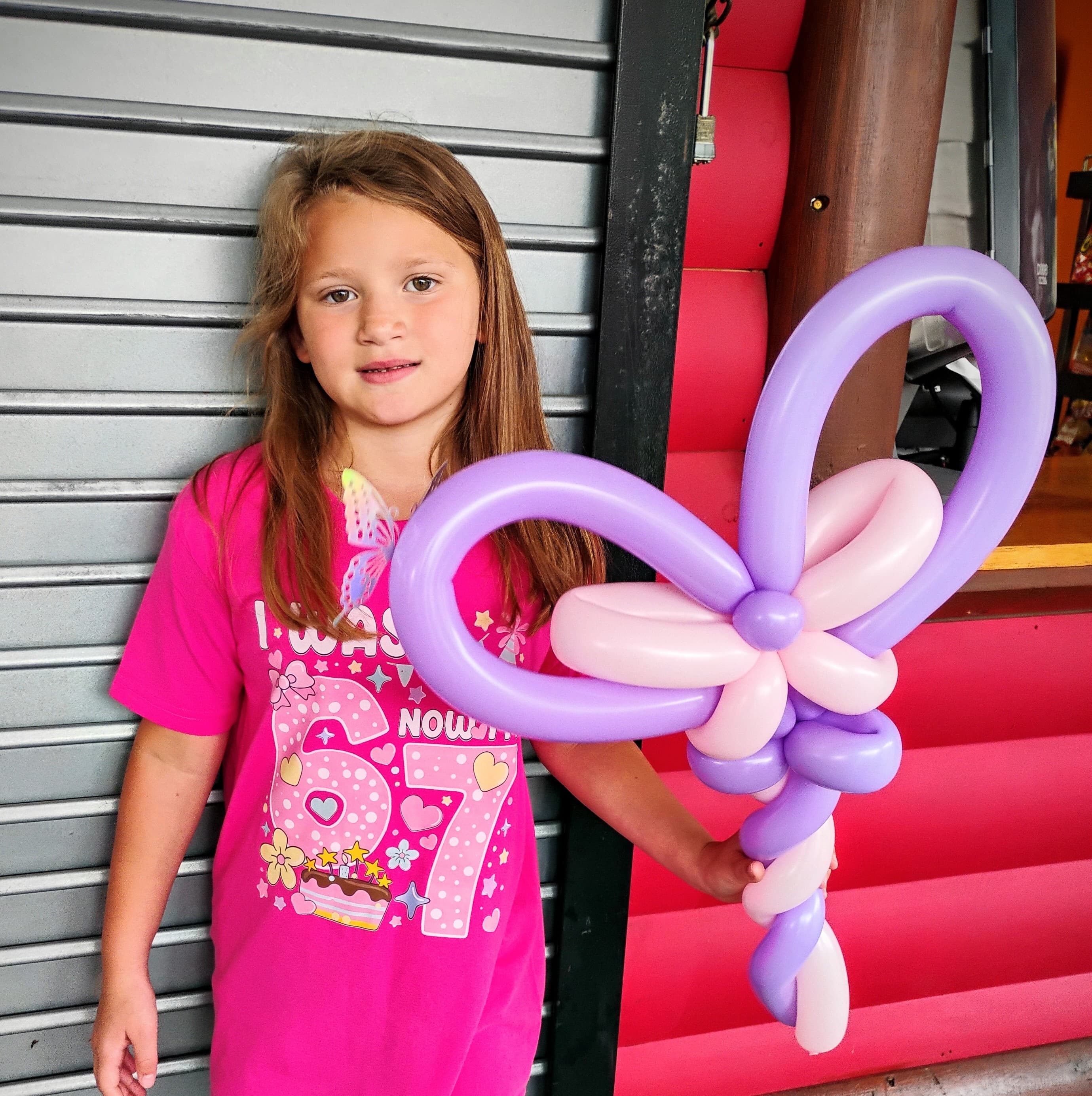 Birthday girl with a purple balloon bow sculpture