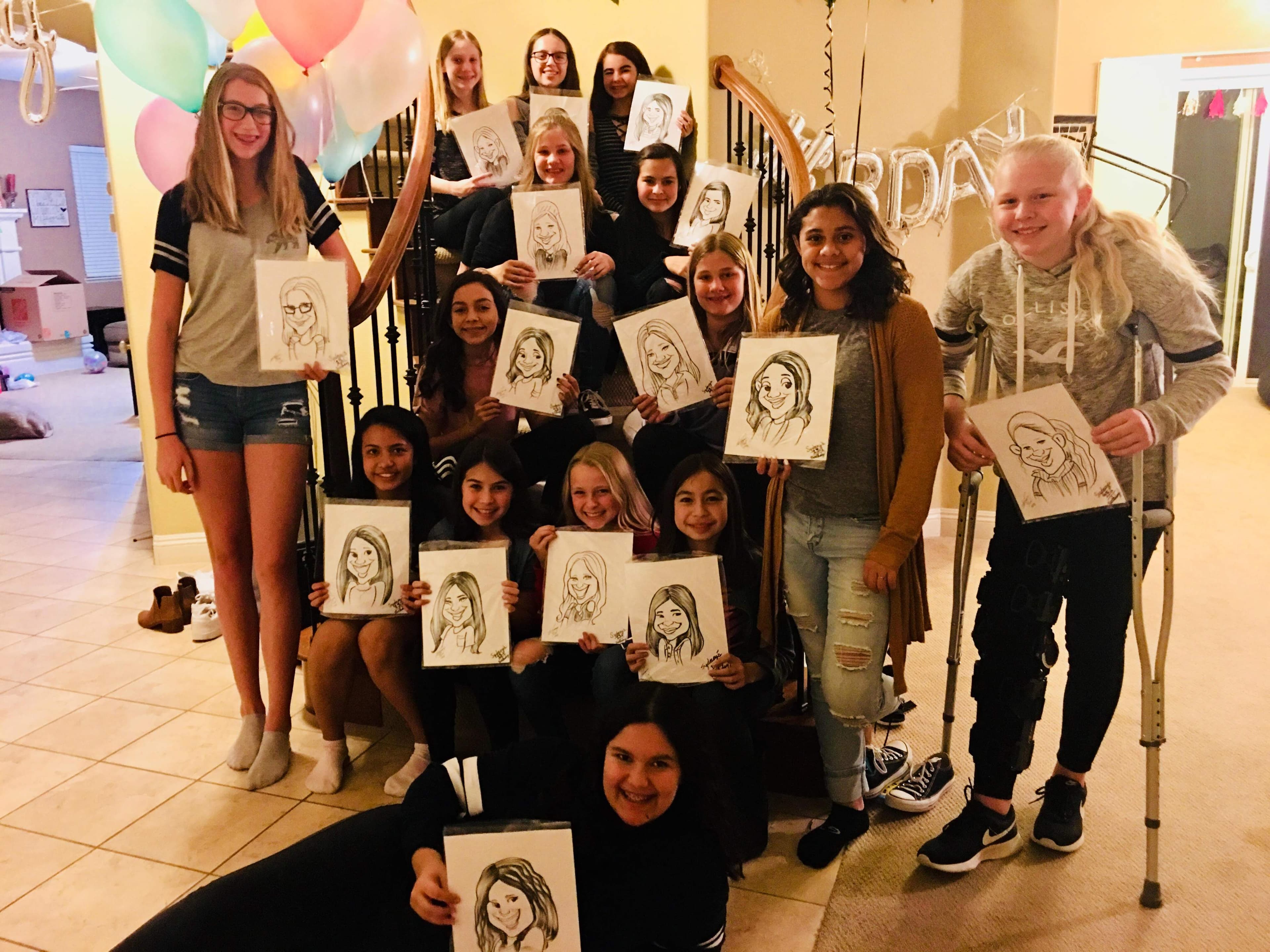 Birthday party group each holding their caricature