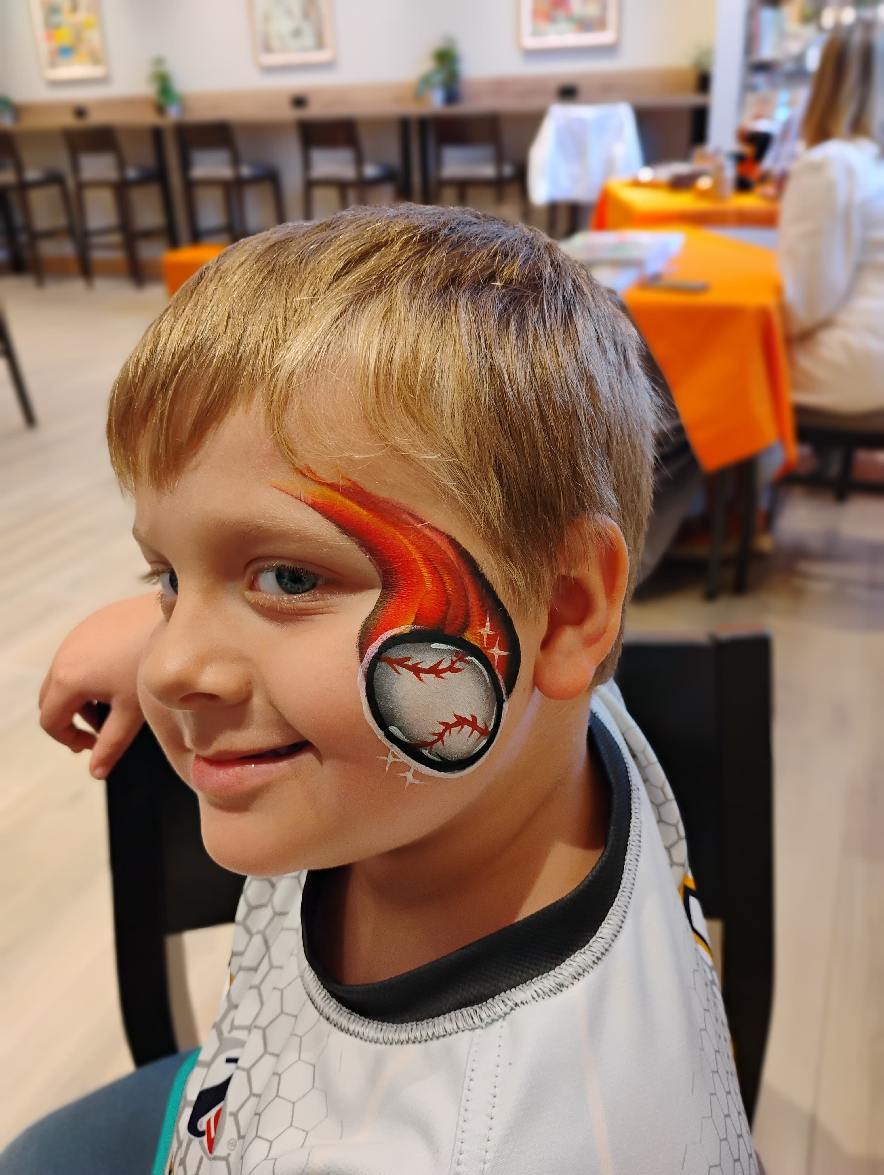 Boy with flaming baseball cheek design