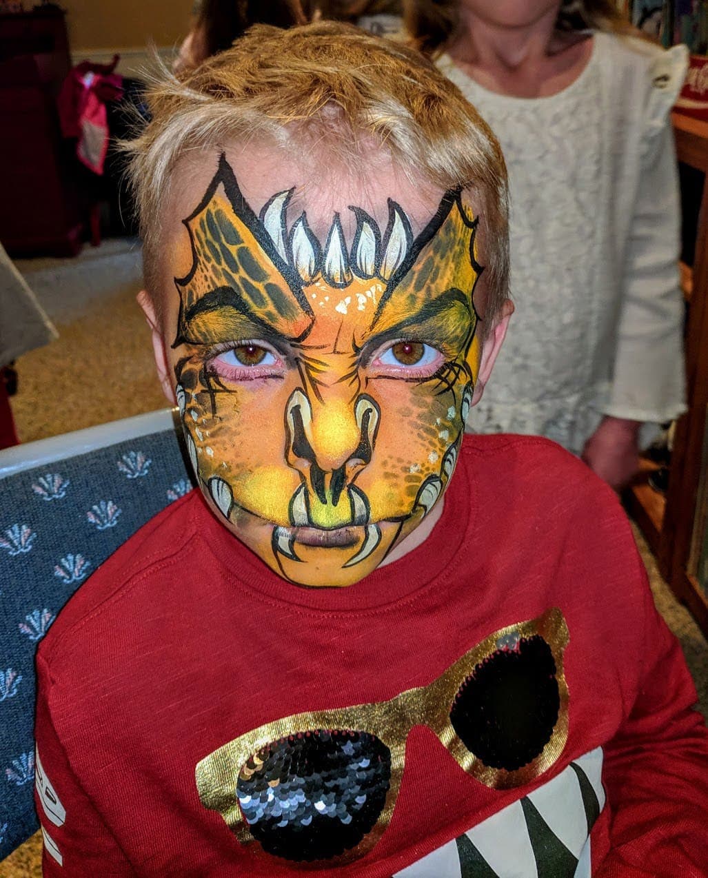 Boy with full-face dragon face paint