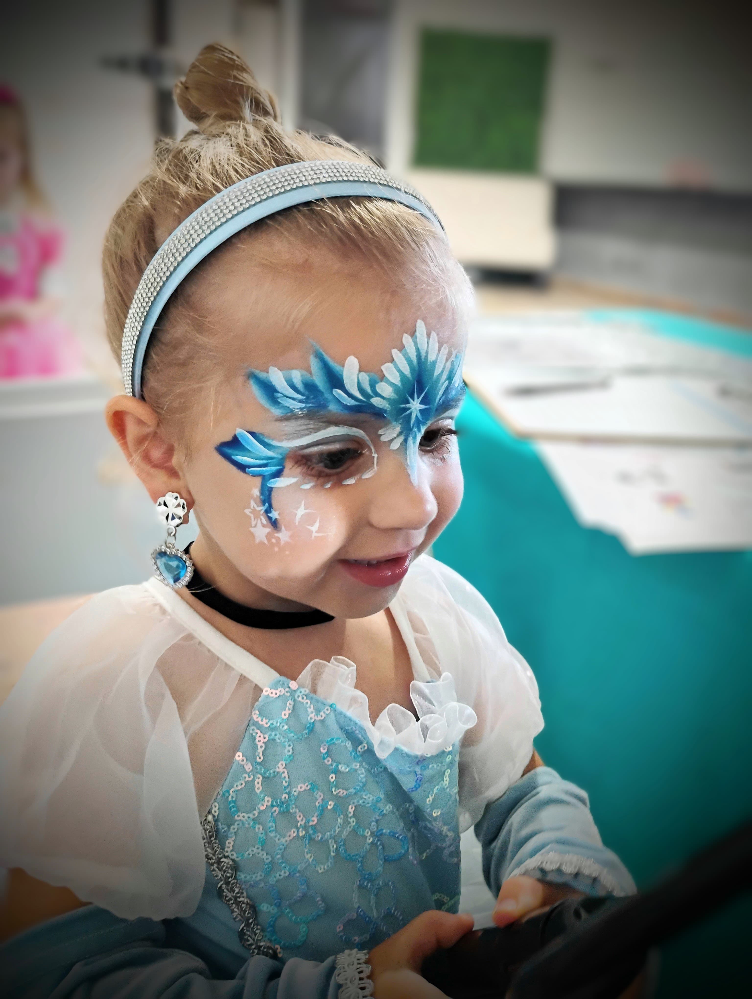 Toddler with blue ice-crystal face paint
