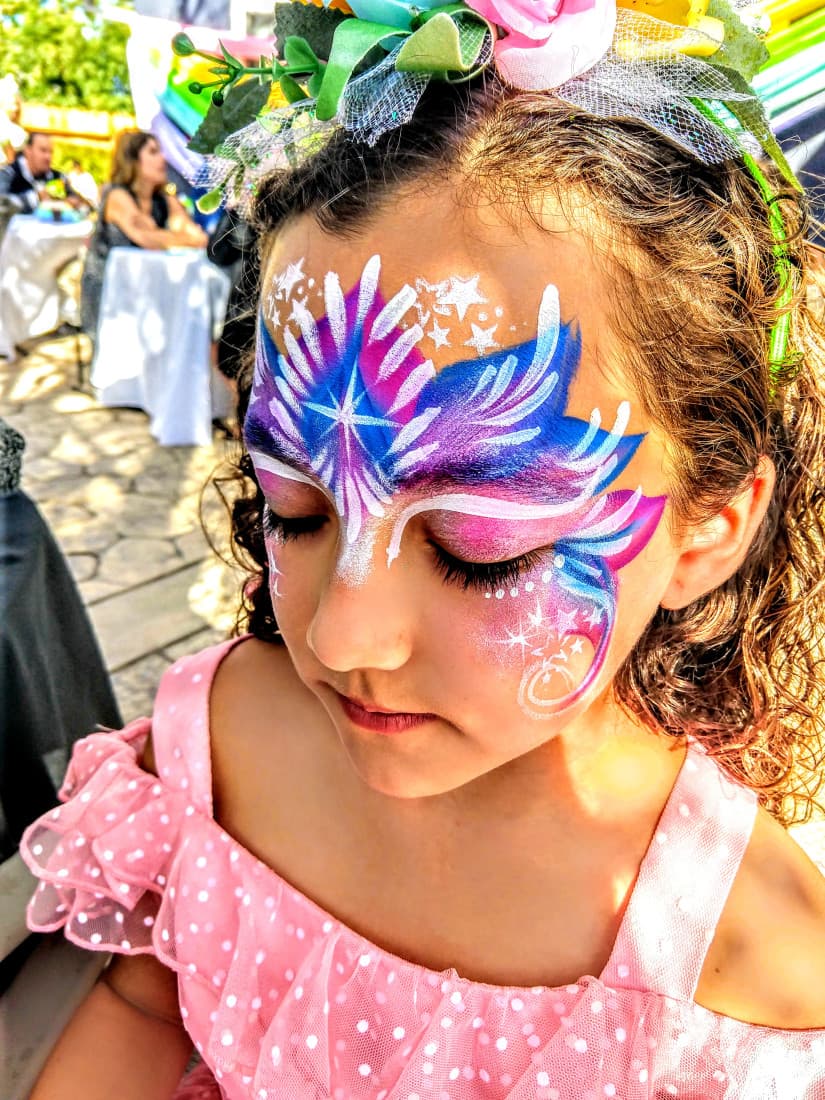 Girl with purple and blue snowflake face paint
